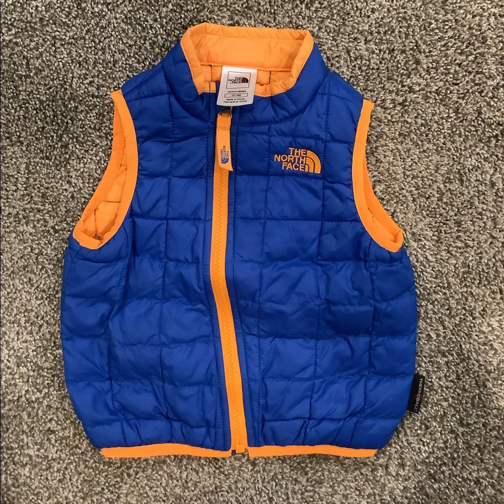 The North Face vest blue and orange. Infant 12-18m